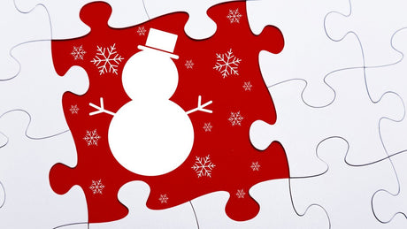 Jigsaw puzzle pieces with white snowman on red background